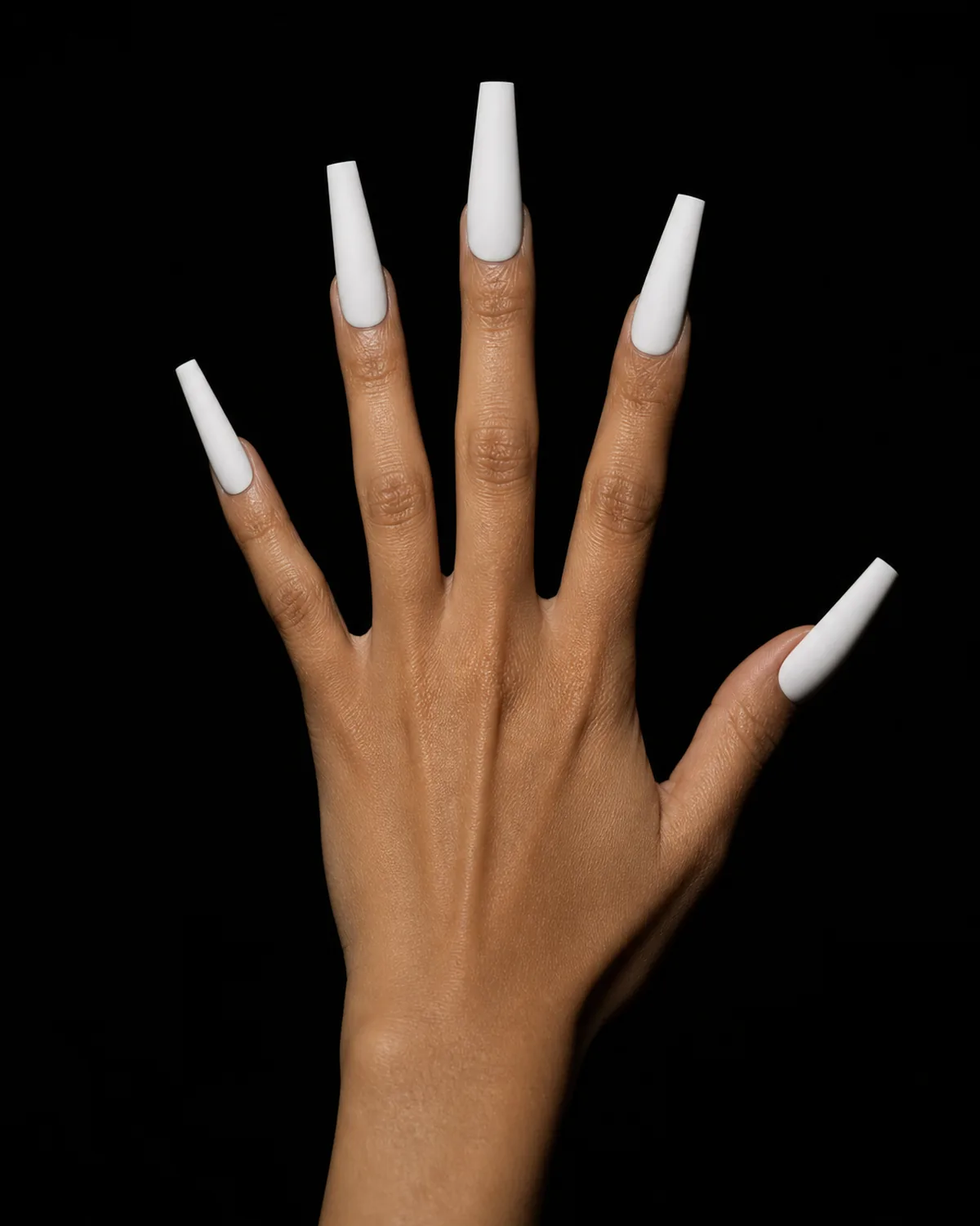 Extra-long coffin acrylic nails in matte white against black background
