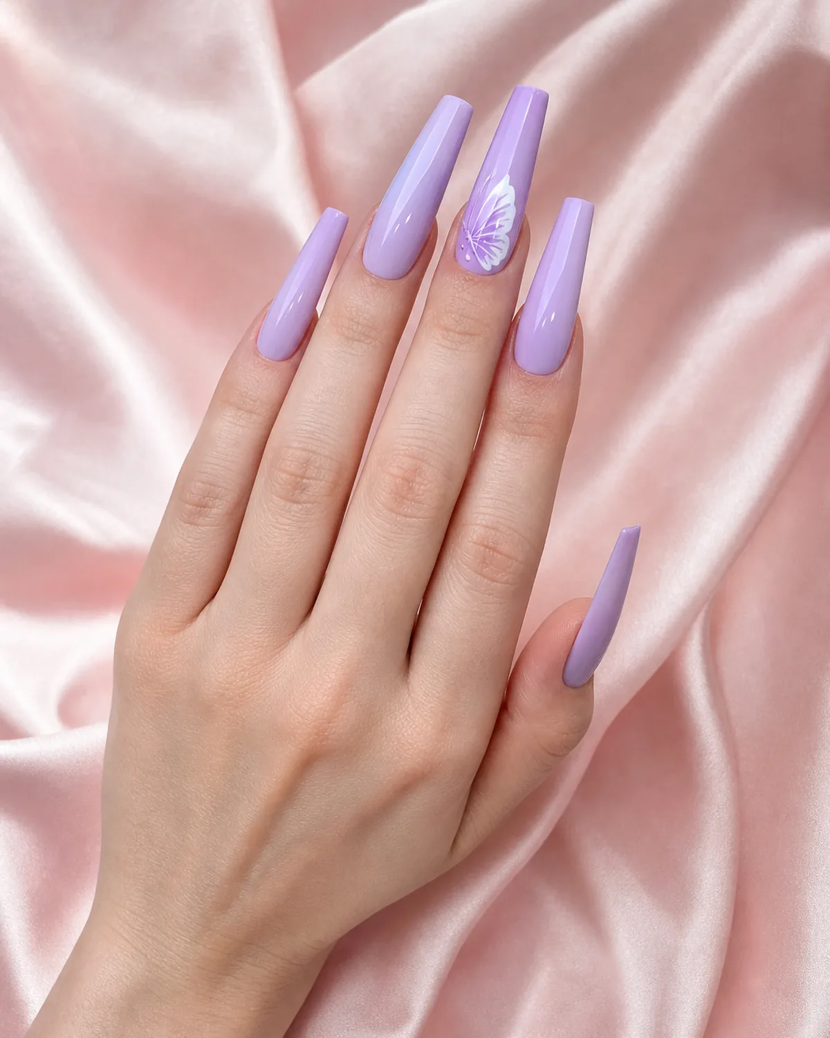 Extra-long coffin acrylic nails in soft lavender with hand-painted butterfly accent on blush silk