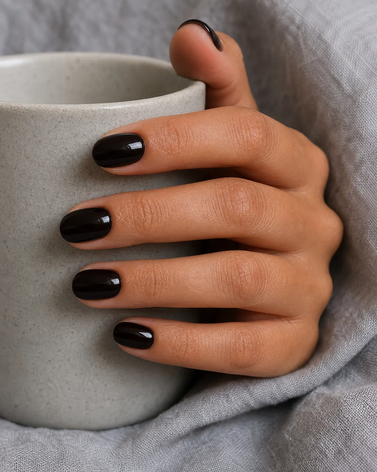Warm black-brown boundary cream on medium round nails