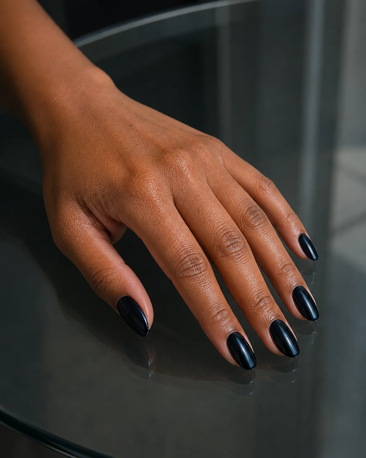 Cool blue-black gloss on oval nails