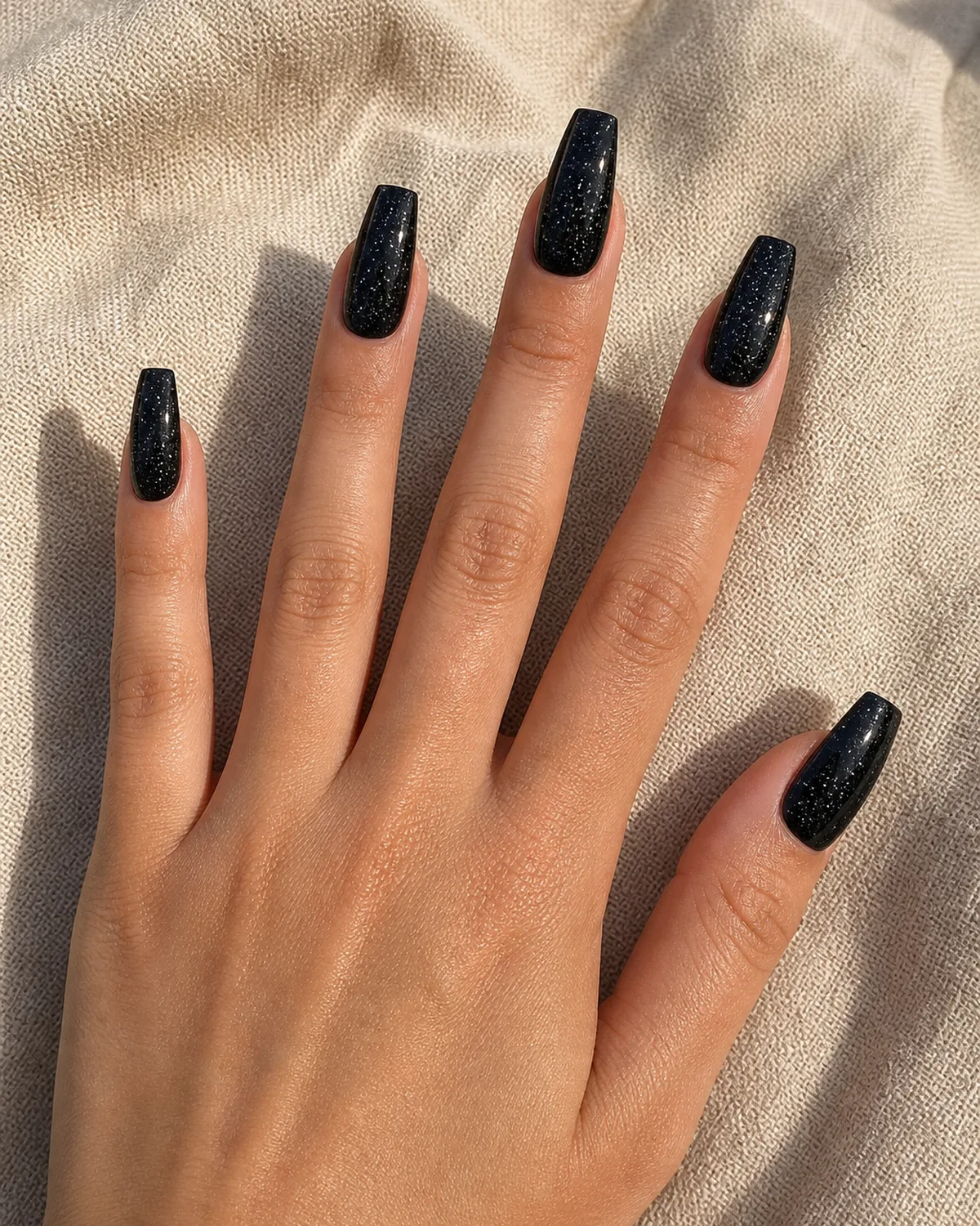Black cream with fine silver glitter on coffin nails