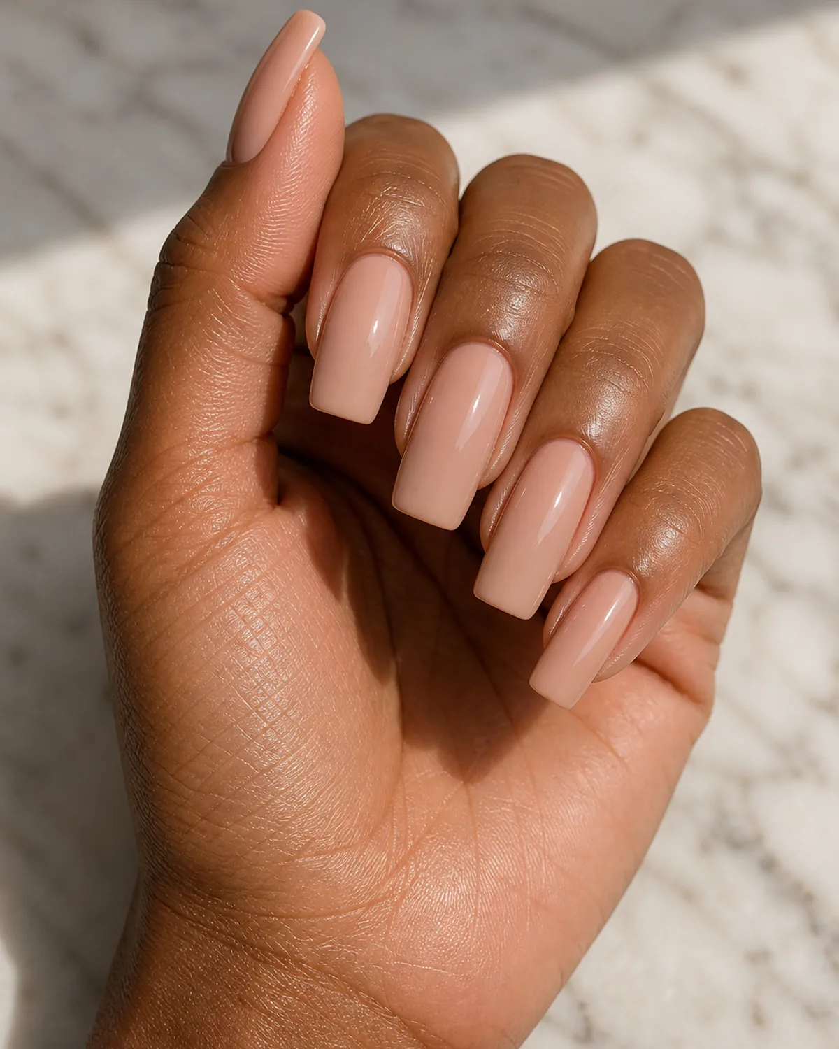 Classic nude gloss on long squoval nails