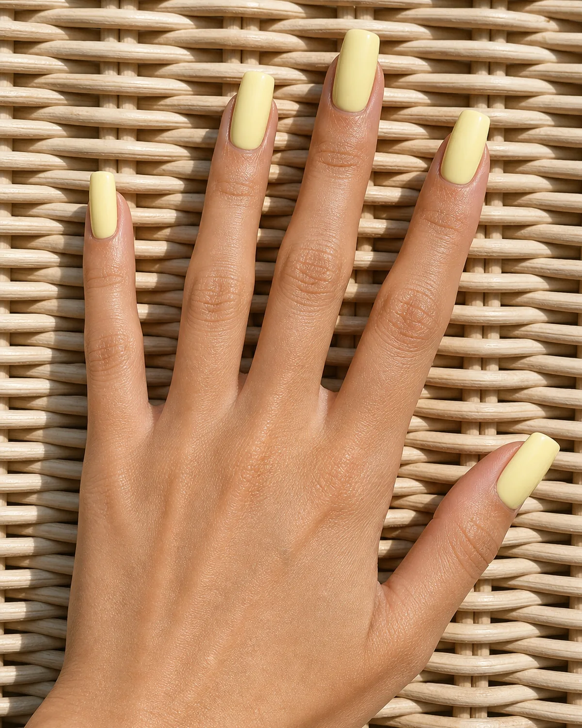 Pastel butter yellow on long squoval nails