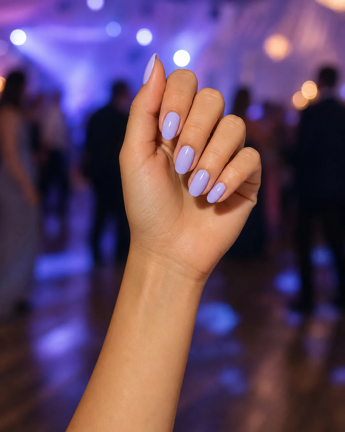 Soft lavender on medium oval nails, hand mid-motion on the dance floor with soft light trails in background