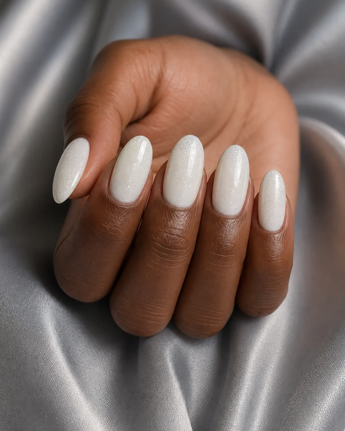 Glitter-fleck white on long oval nails