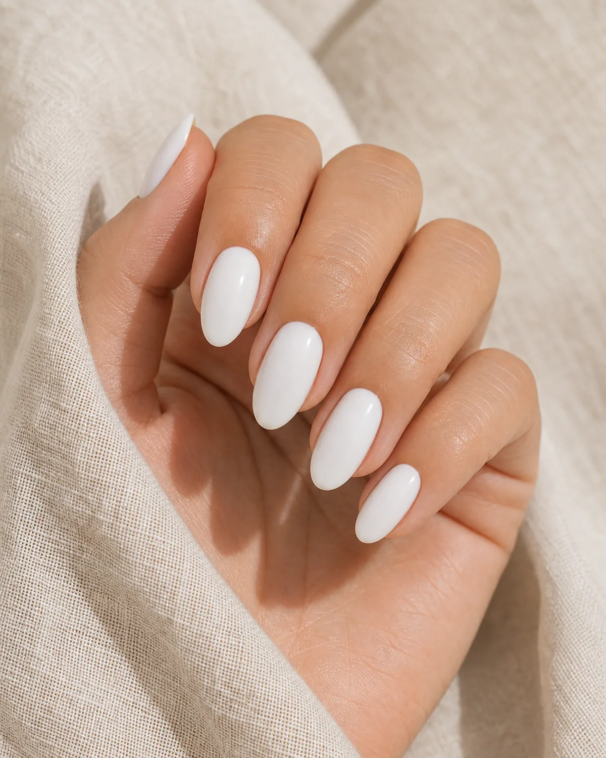 Milky white cream on almond nails