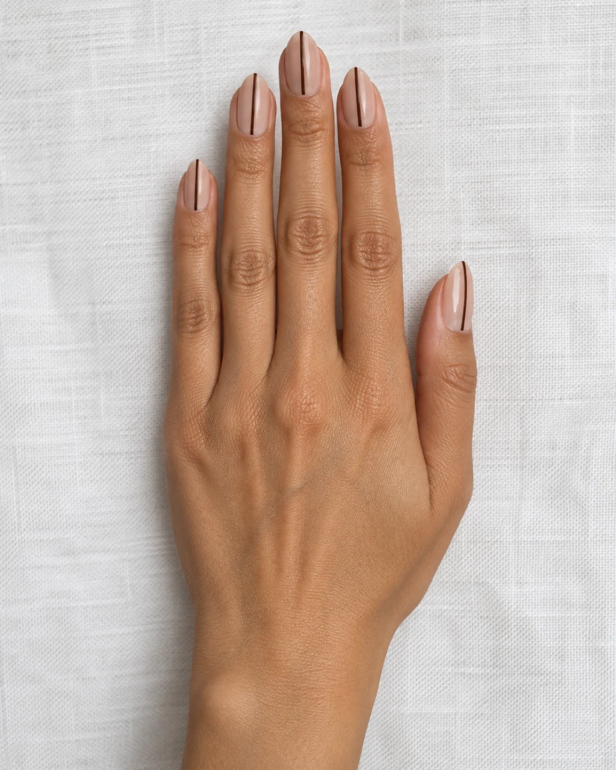 Single Thin Accent Line on Nude Almond nail design close-up